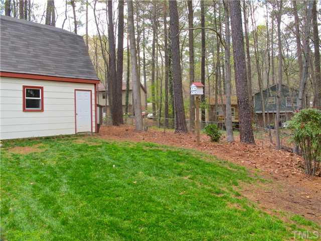6509 Dew Drop Court Raleigh, NC 27613 - Photo 23 of 25 a view of a house with backyard and garden