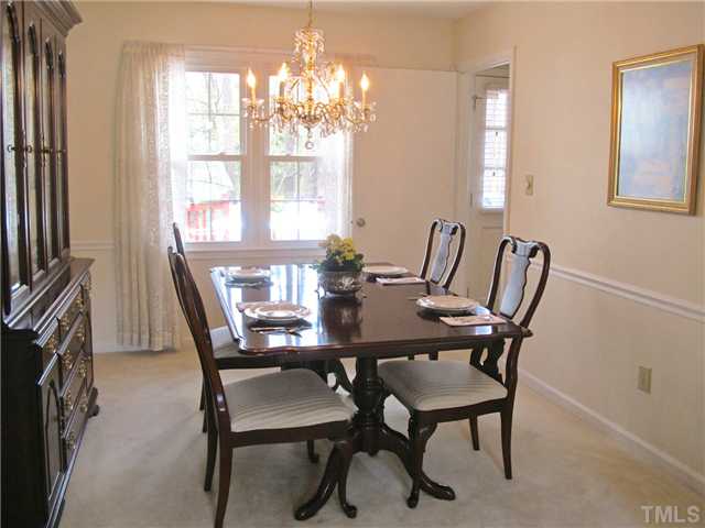 6509 Dew Drop Court Raleigh, NC 27613 - Photo 7 of 25 a view of a dining room with furniture and chandelier