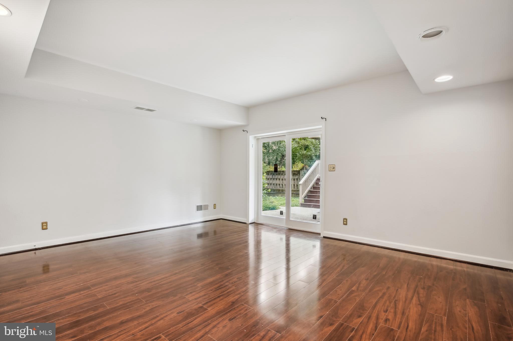 4516 Foxhall Crescent Northwest Washington, DC 20007 - Photo 26 of 30 wooden floor in an empty room with a window