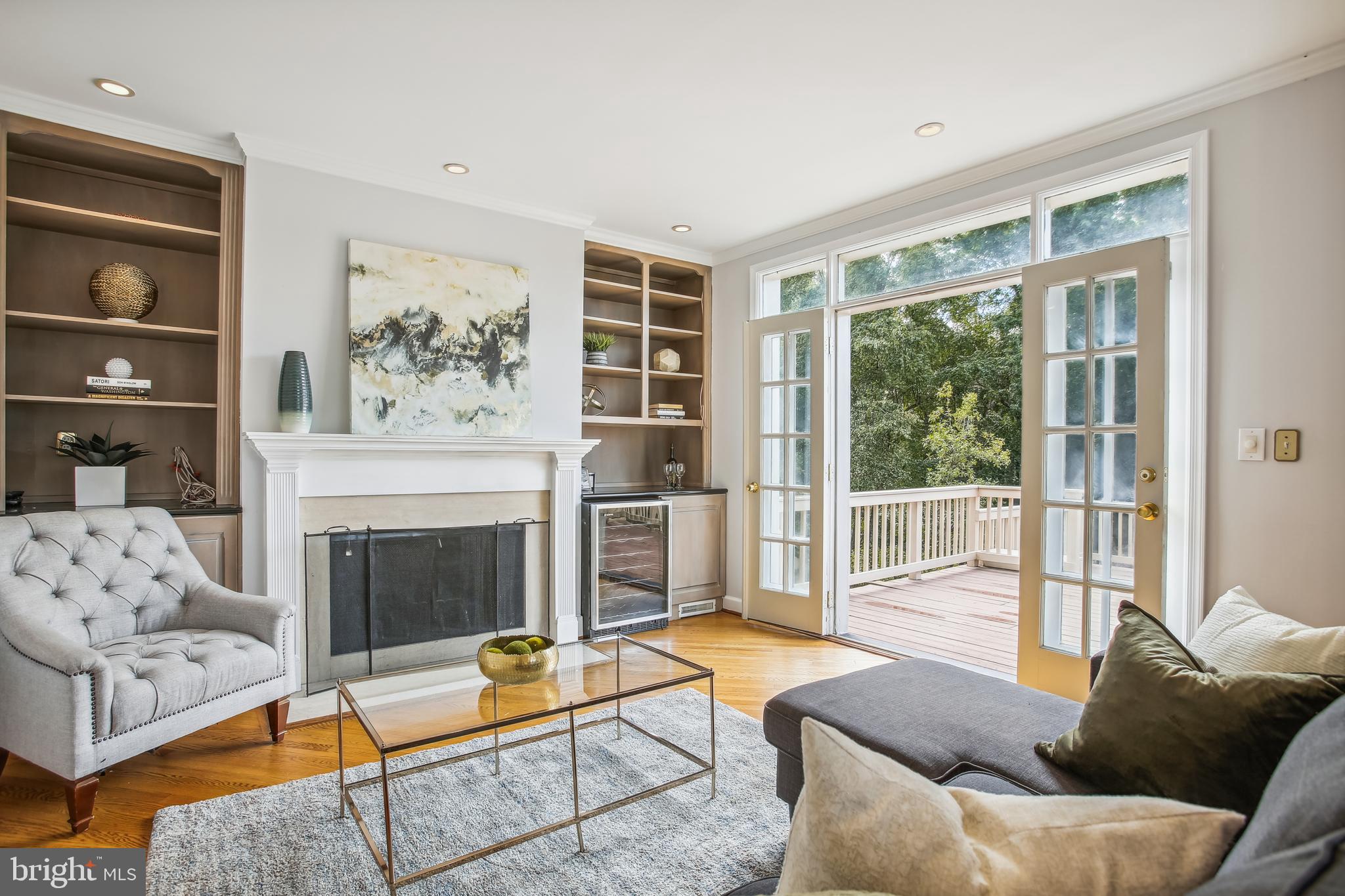 4516 Foxhall Crescent Northwest Washington, DC 20007 - Photo 3 of 30 a living room with furniture a flat screen tv and a fireplace