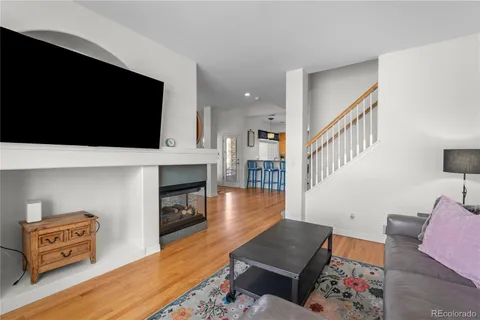 a living room with furniture a flat screen tv and a fireplace