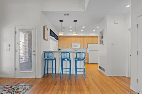 a view of hallway with furniture and wooden floor