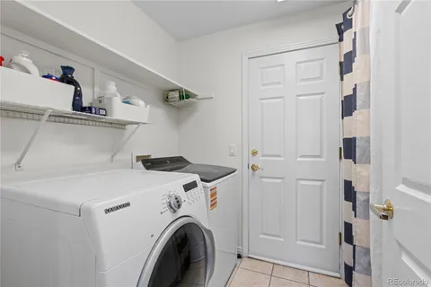 a view of washer and dryer with kitchen in the background