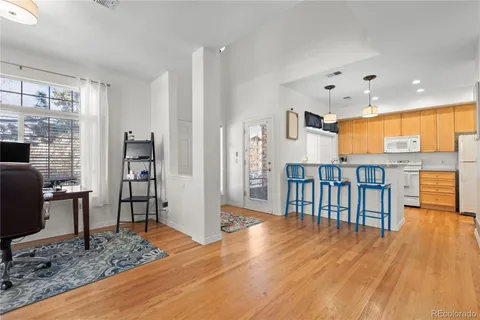 a view of a living room kitchen and a wooden floor