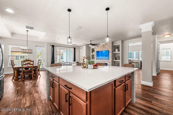 a view of kitchen island kitchen island sink stove and living room view