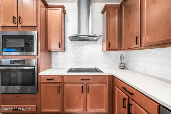 a kitchen with stainless steel appliances granite countertop a sink stove and microwave