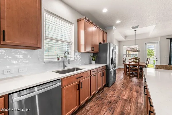 a kitchen with stainless steel appliances granite countertop sink stove top oven and cabinets