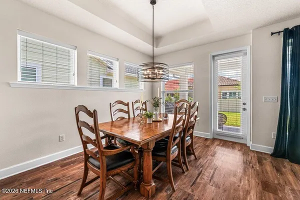 a view of a dining room with furniture window and wooden floor
