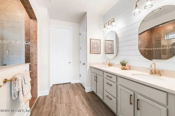 a spacious bathroom with a double vanity sink and a mirror