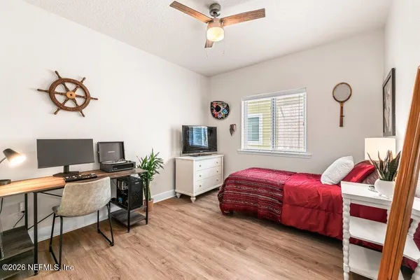 a bedroom with a bed and wooden floor