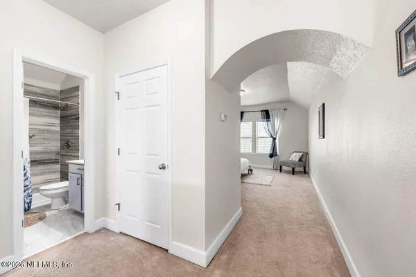 a very nice looking room with white walls and a bathroom