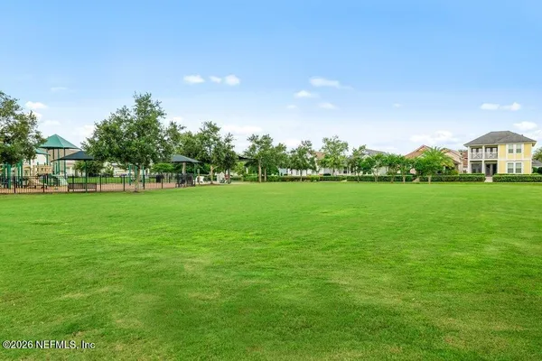 a view of yard with swimming pool and green space
