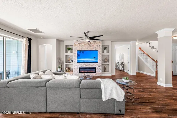 a bedroom with a bed a couch and a chandelier