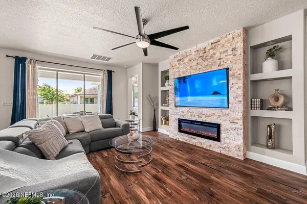 a living room with furniture and a fireplace
