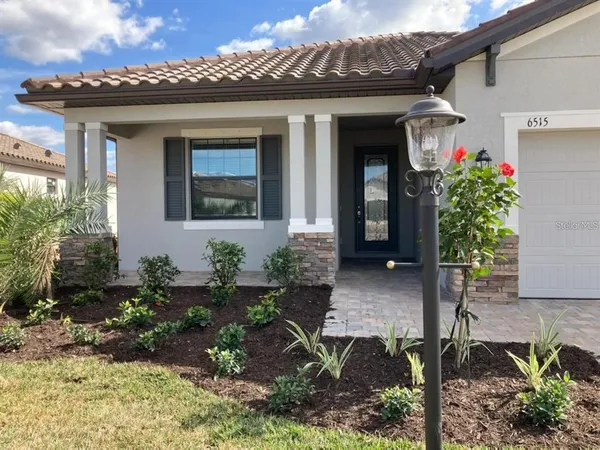 a view of a house with potted plants