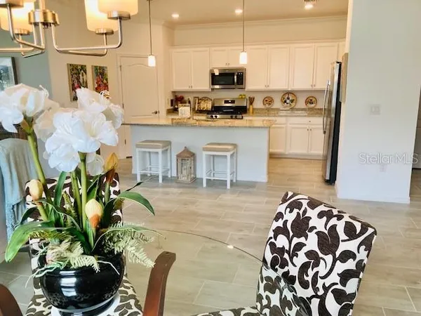 a kitchen with stainless steel appliances kitchen island granite countertop a stove a sink and a microwave
