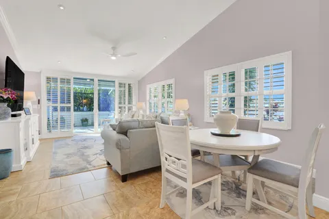 a living room with furniture a flat screen tv and a large window