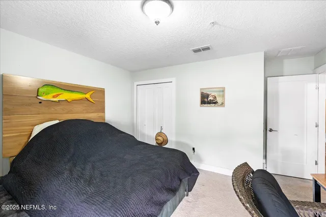 a bedroom with a bed and couch
