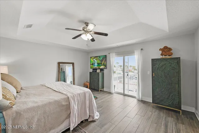 a spacious bedroom with a bed and a chandelier