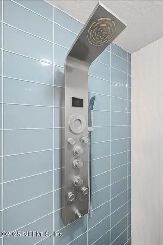a bathroom with a shower and a mirror
