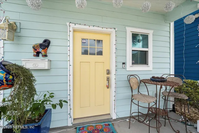 a front view of a house with outdoor seating