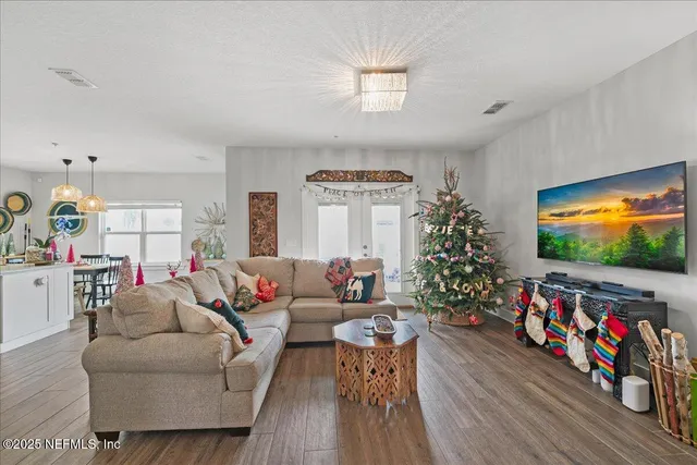 a living room with furniture and a flat screen tv