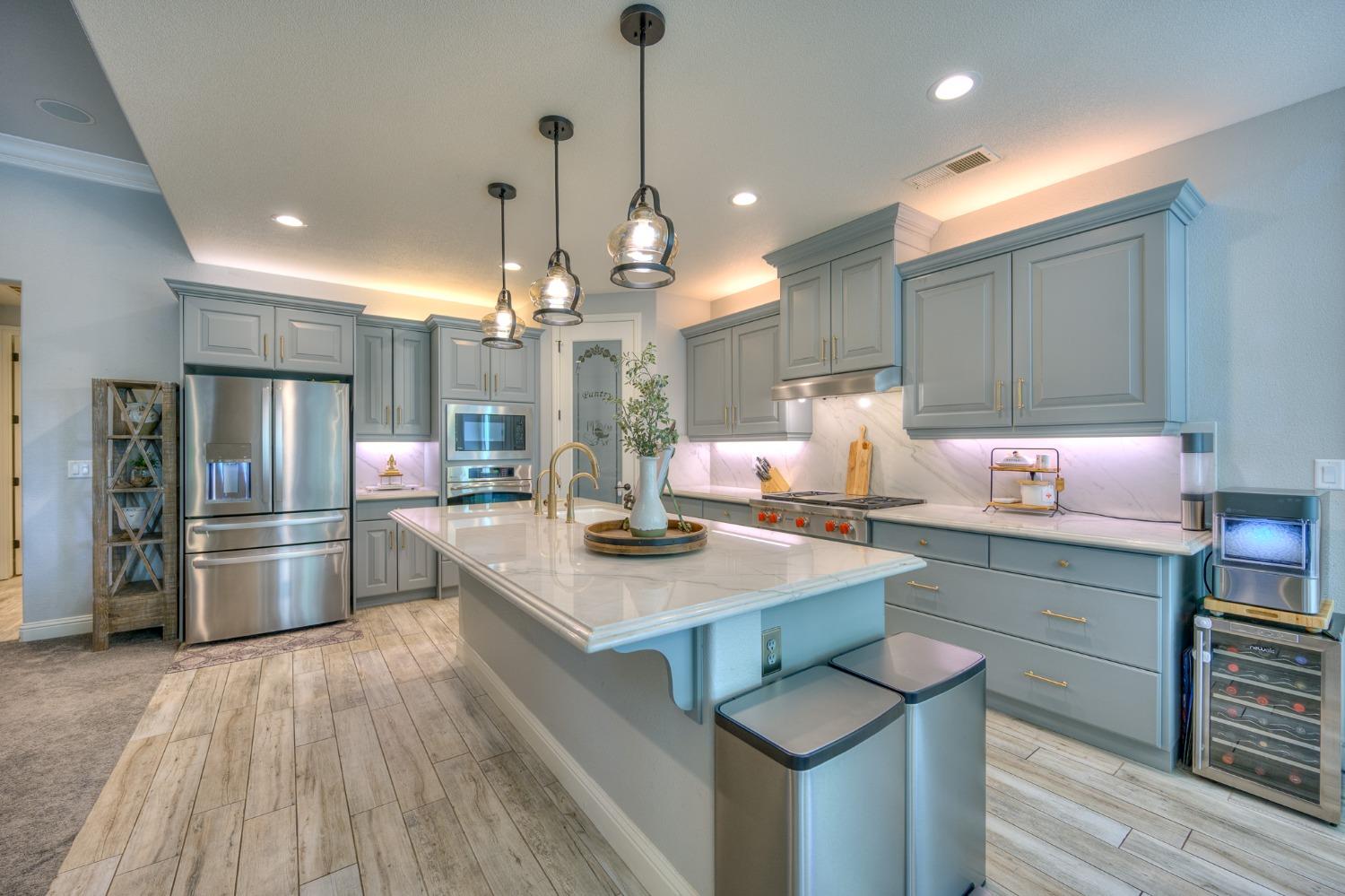 3731 Serena Avenue Clovis, CA 93619 - Photo 14 of 54 a kitchen with a sink a counter space appliances and cabinets