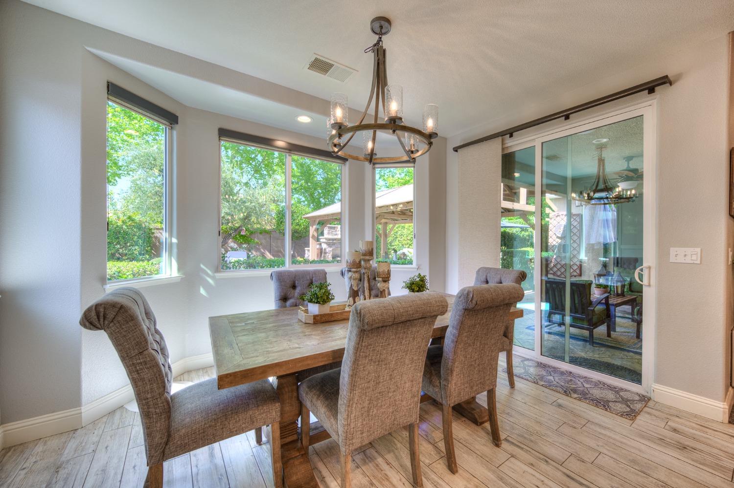 3731 Serena Avenue Clovis, CA 93619 - Photo 17 of 54 a view of a dining room with furniture window and wooden floor