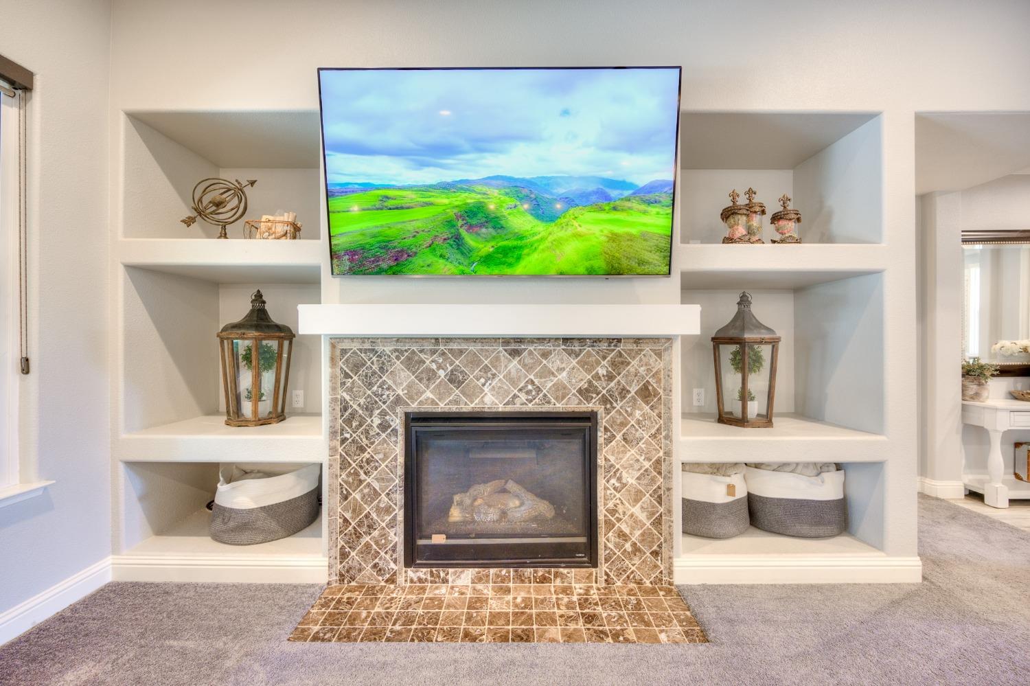 3731 Serena Avenue Clovis, CA 93619 - Photo 18 of 54 a living room with a fireplace and a floor to ceiling window
