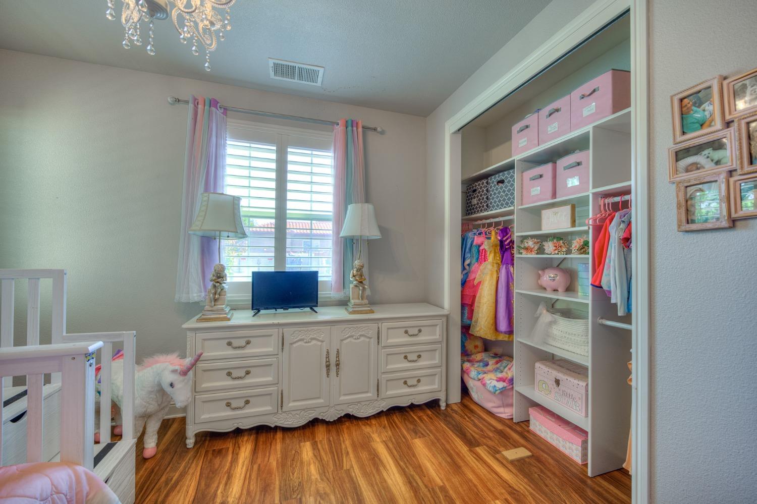 3731 Serena Avenue Clovis, CA 93619 - Photo 29 of 54 a bedroom with furniture and a wooden floor