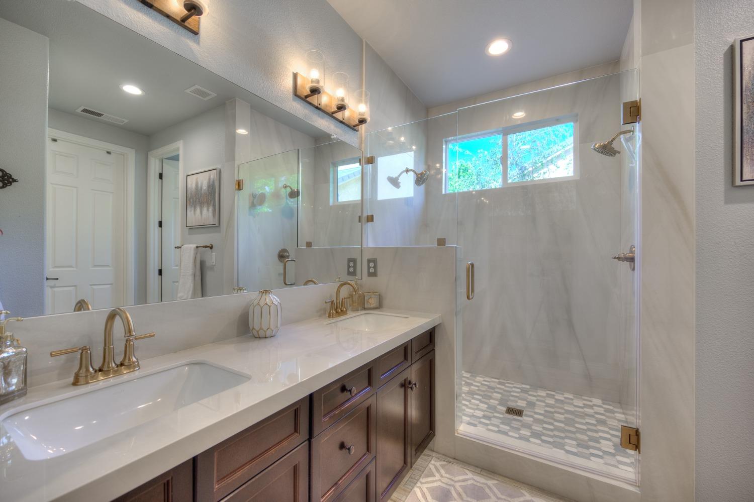 3731 Serena Avenue Clovis, CA 93619 - Photo 32 of 54 a bathroom with a double vanity sink mirror and shower