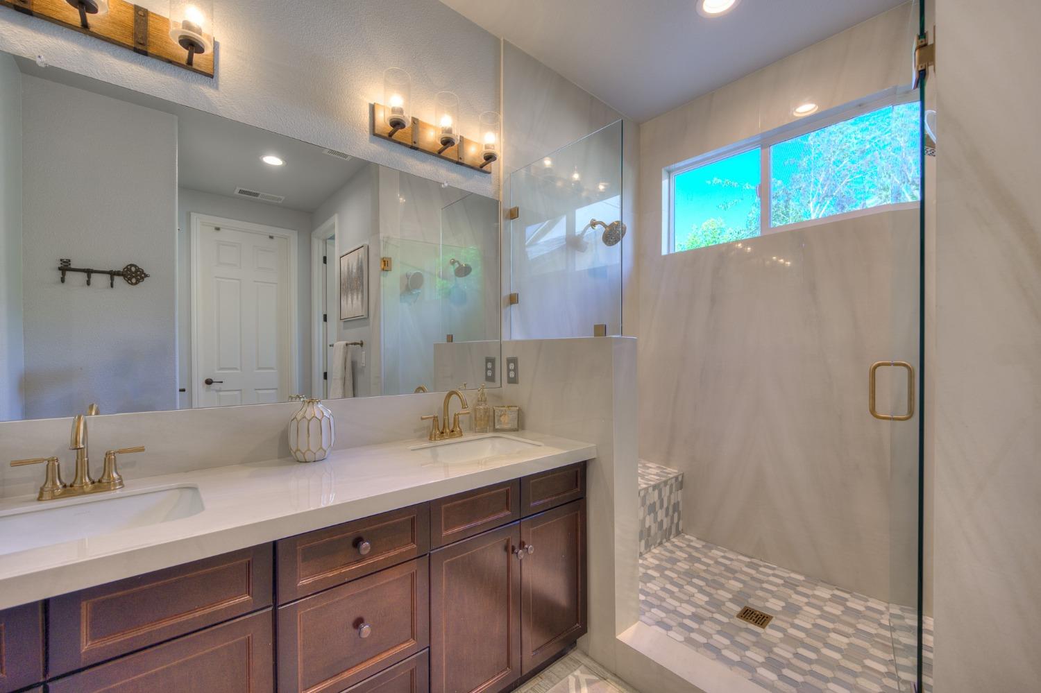 3731 Serena Avenue Clovis, CA 93619 - Photo 33 of 54 a bathroom with a double vanity sink mirror and shower