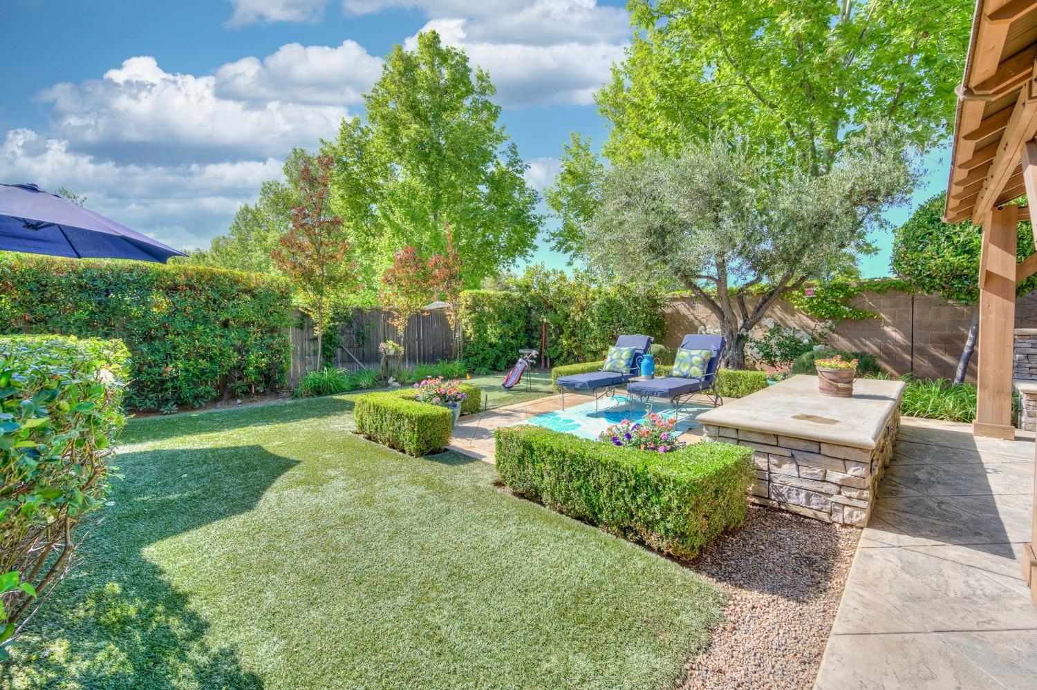 3731 Serena Avenue Clovis, CA 93619 - Photo 38 of 54 a view of a table and chairs in the garden