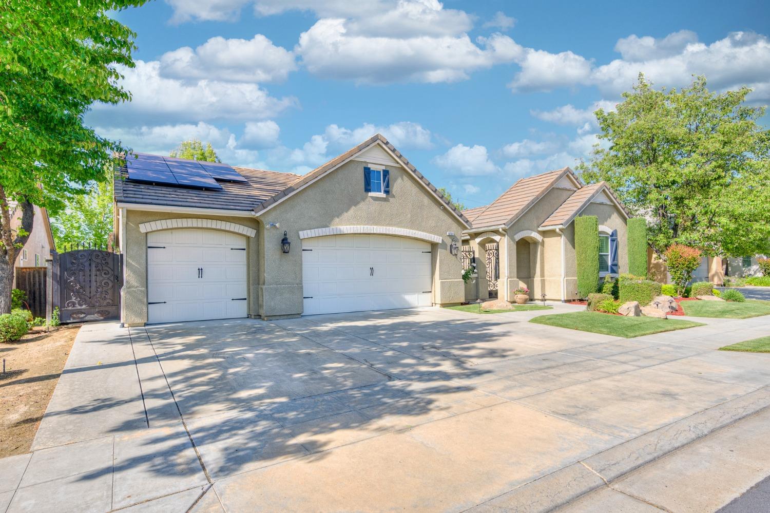 3731 Serena Avenue Clovis, CA 93619 - Photo 5 of 54 a view of a house with a patio and a yard