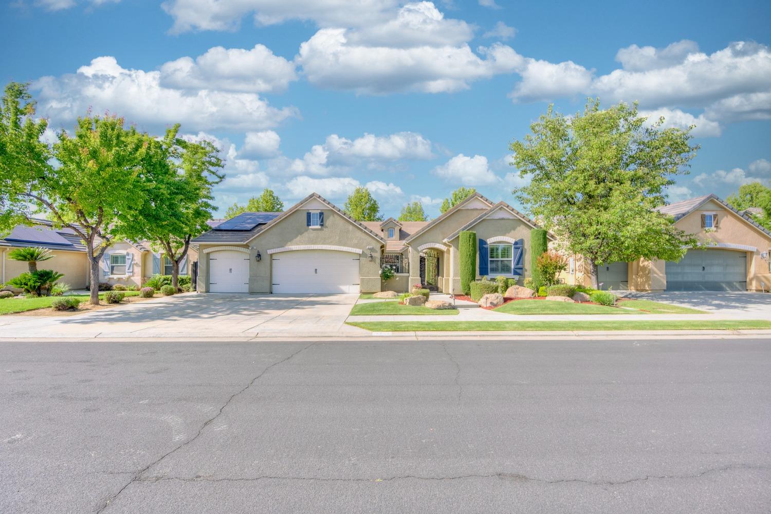 3731 Serena Avenue Clovis, CA 93619 - Photo 6 of 54 a front view of a house with a yard and trees