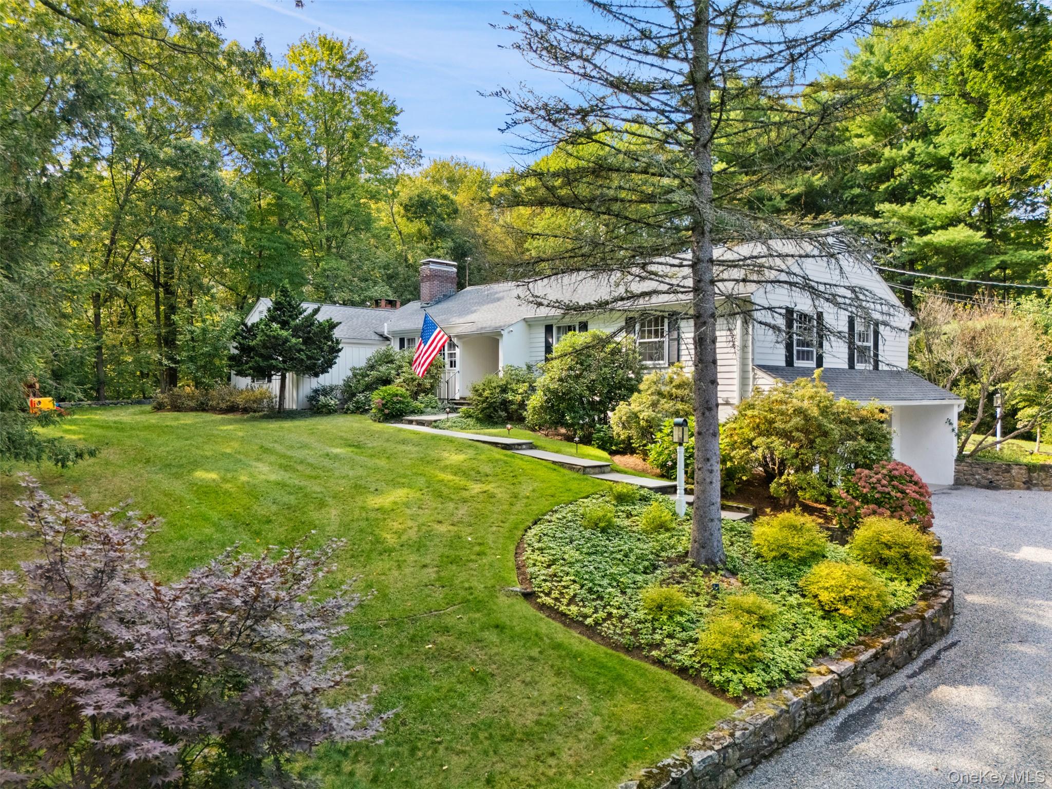 43 Croton Lake Road Katonah, NY 10536 - Photo 2 of 26 a front view of a house with garden