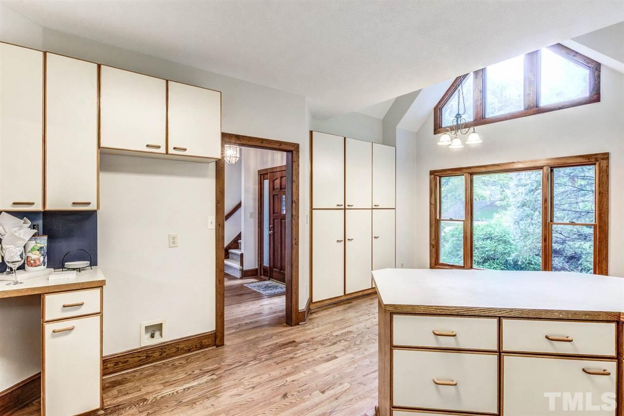 7604 Glenharden Drive Raleigh, NC 27613 - Photo 11 of 30 a kitchen with stainless steel appliances granite countertop a refrigerator a stove and a sink with wooden floor