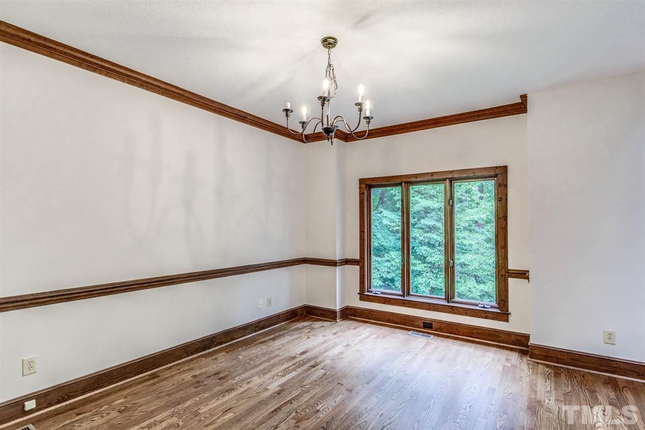 7604 Glenharden Drive Raleigh, NC 27613 - Photo 13 of 30 a view of an empty room with wooden floor and a window