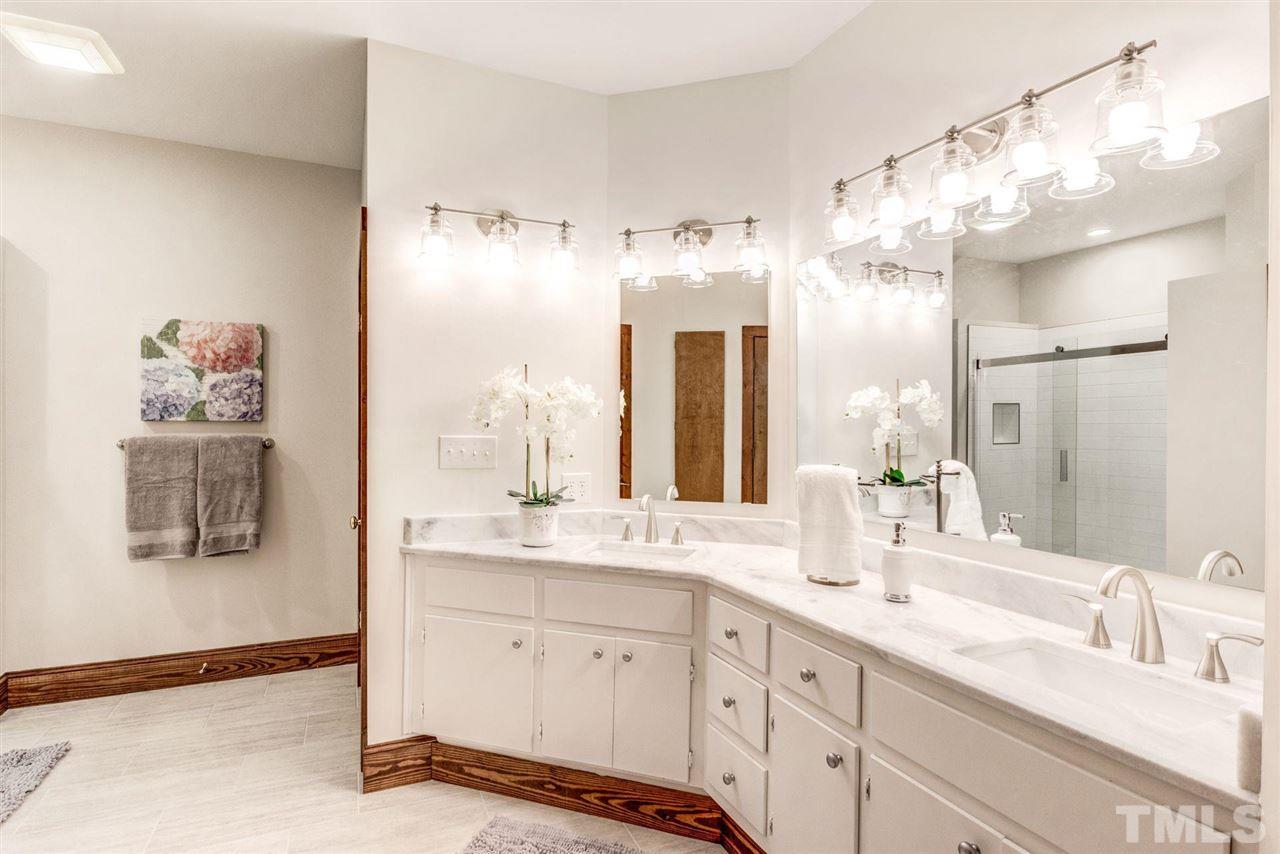 7604 Glenharden Drive Raleigh, NC 27613 - Photo 17 of 30 a bathroom with a double vanity sink mirror and