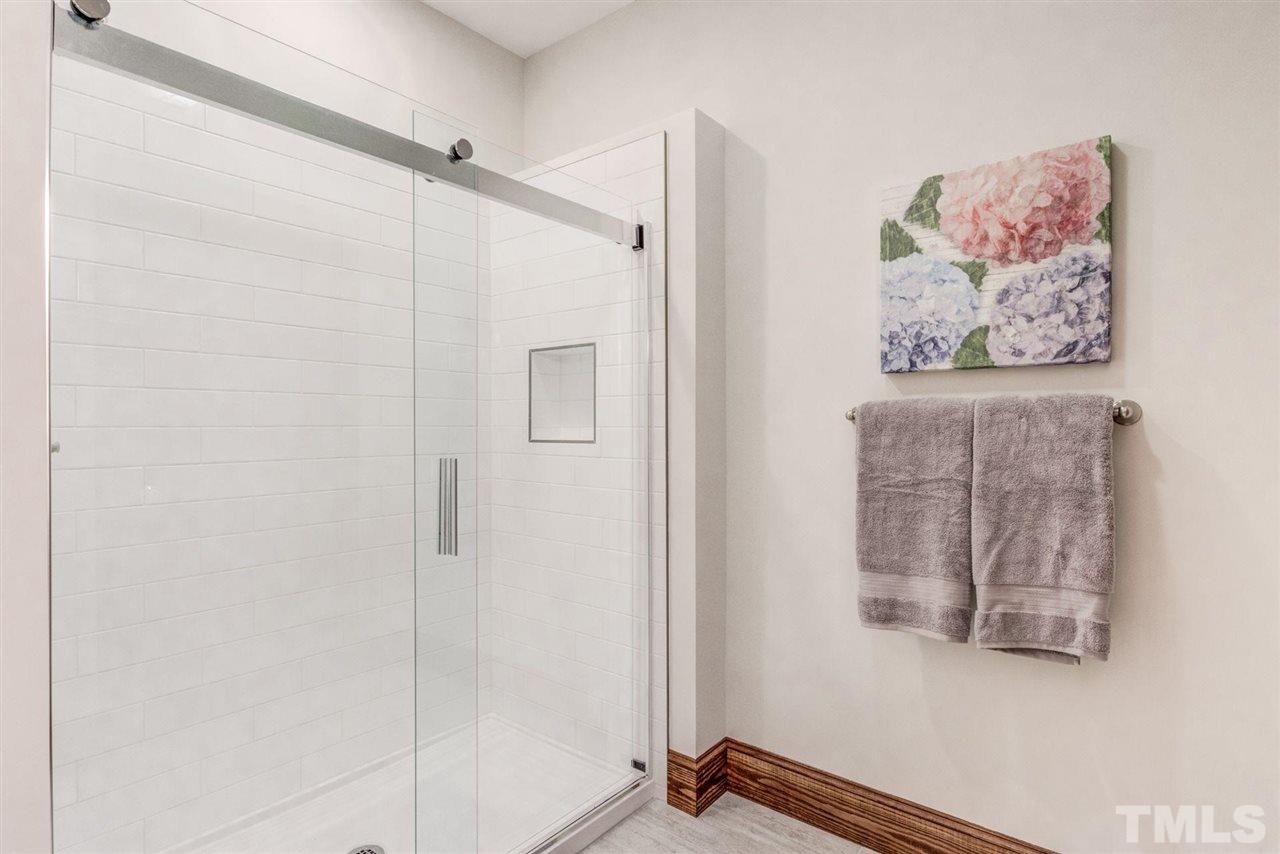 7604 Glenharden Drive Raleigh, NC 27613 - Photo 18 of 30 a view of a hallway with paintings on the wall