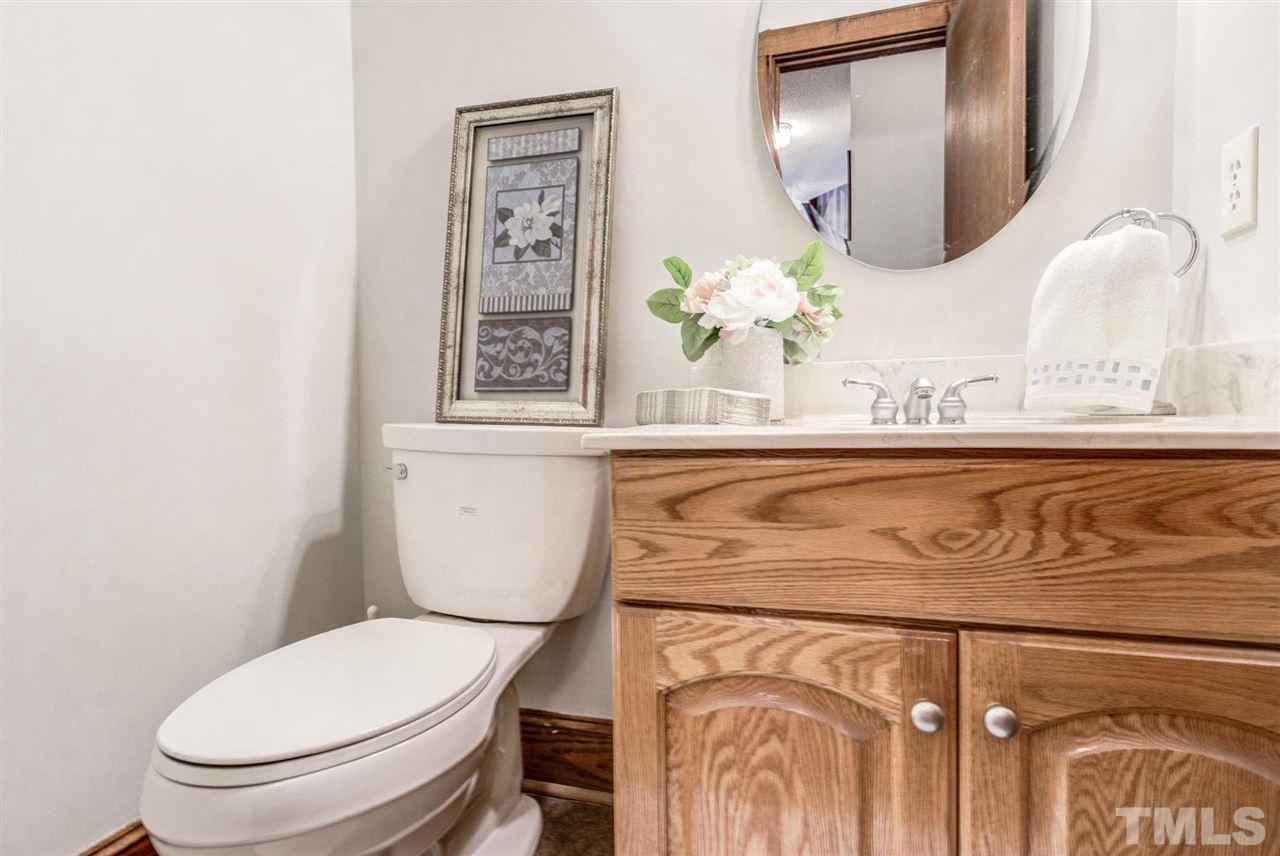 7604 Glenharden Drive Raleigh, NC 27613 - Photo 19 of 30 a bathroom with a toilet sink and mirror