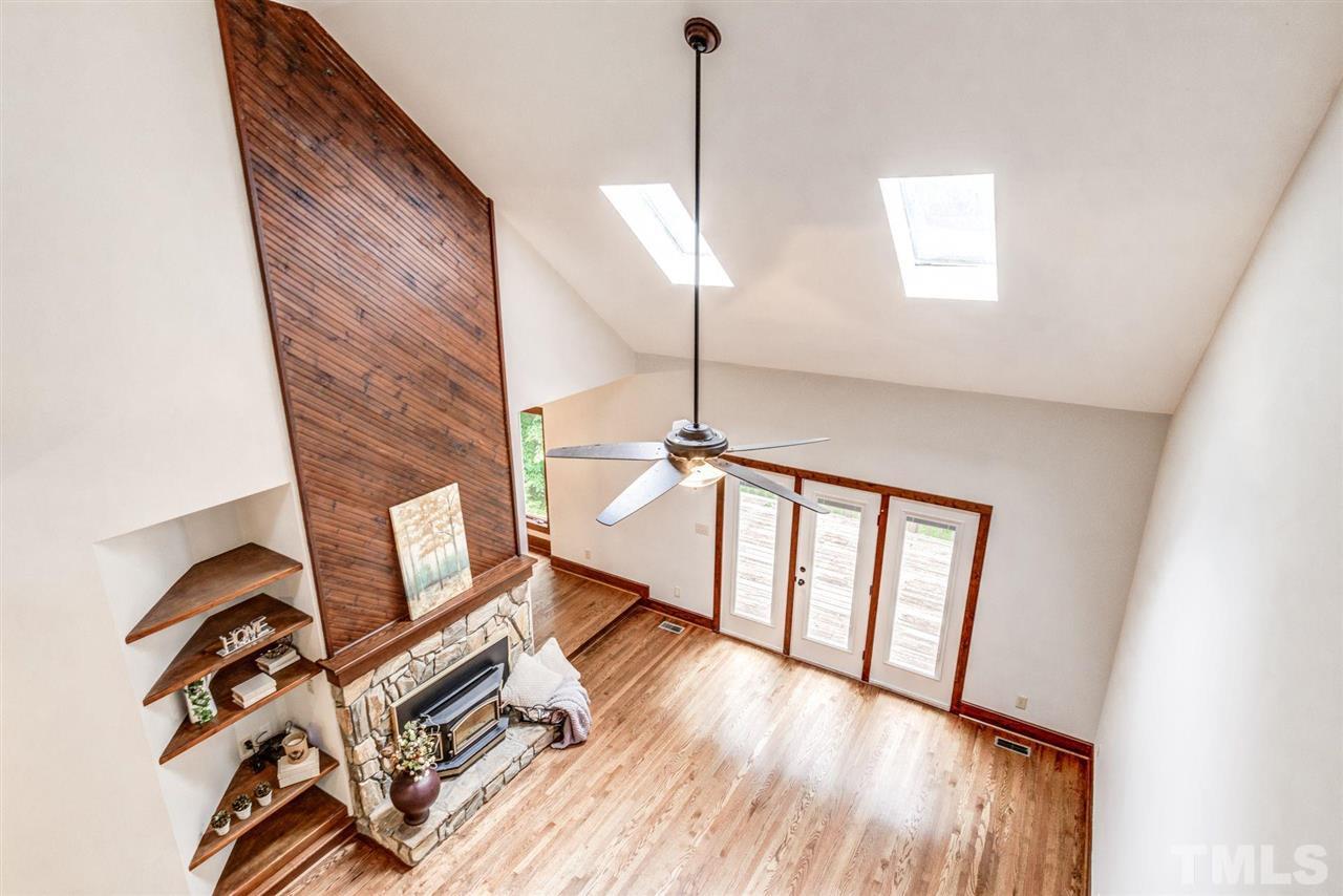 7604 Glenharden Drive Raleigh, NC 27613 - Photo 21 of 30 a view of a livingroom with wooden floor and a ceiling fan