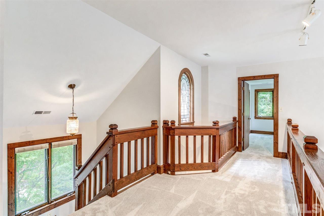7604 Glenharden Drive Raleigh, NC 27613 - Photo 24 of 30 a view of a hallway with windows and stairs