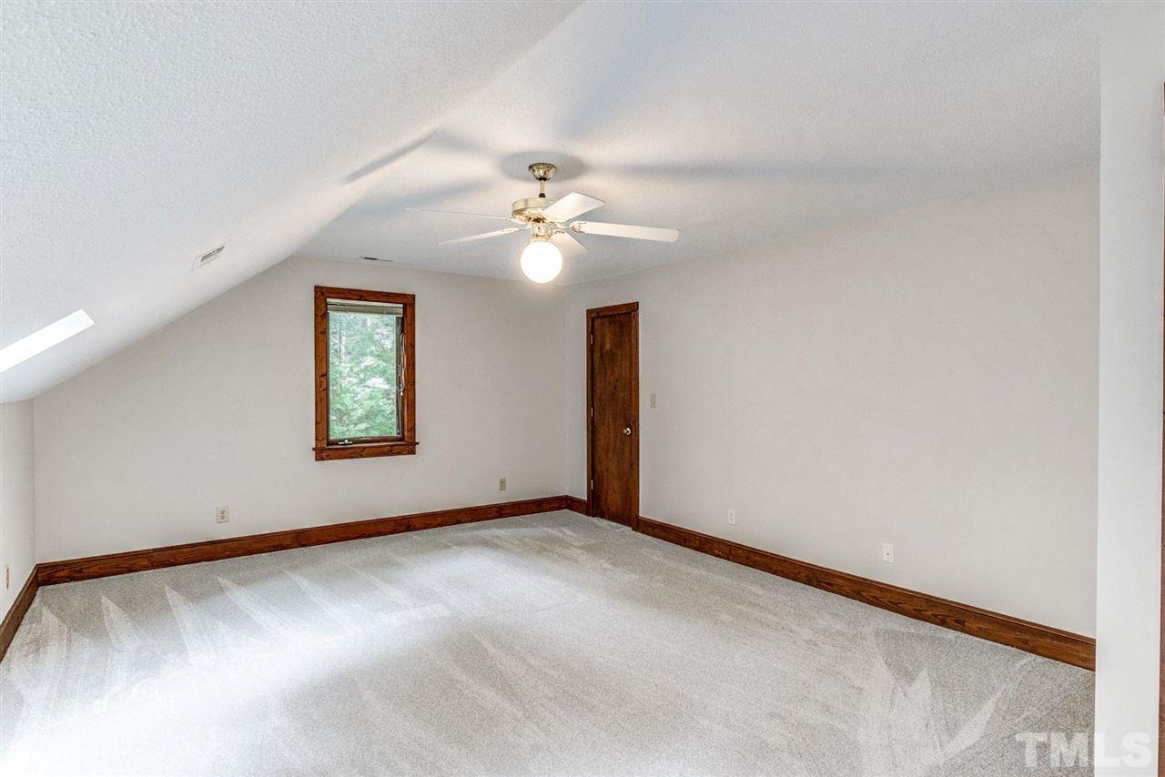 7604 Glenharden Drive Raleigh, NC 27613 - Photo 25 of 30 an empty room with windows and fan