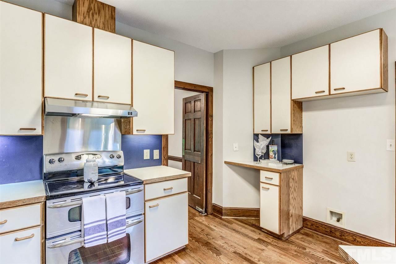 7604 Glenharden Drive Raleigh, NC 27613 - Photo 9 of 30 a kitchen with stainless steel appliances granite countertop a stove a sink and a refrigerator