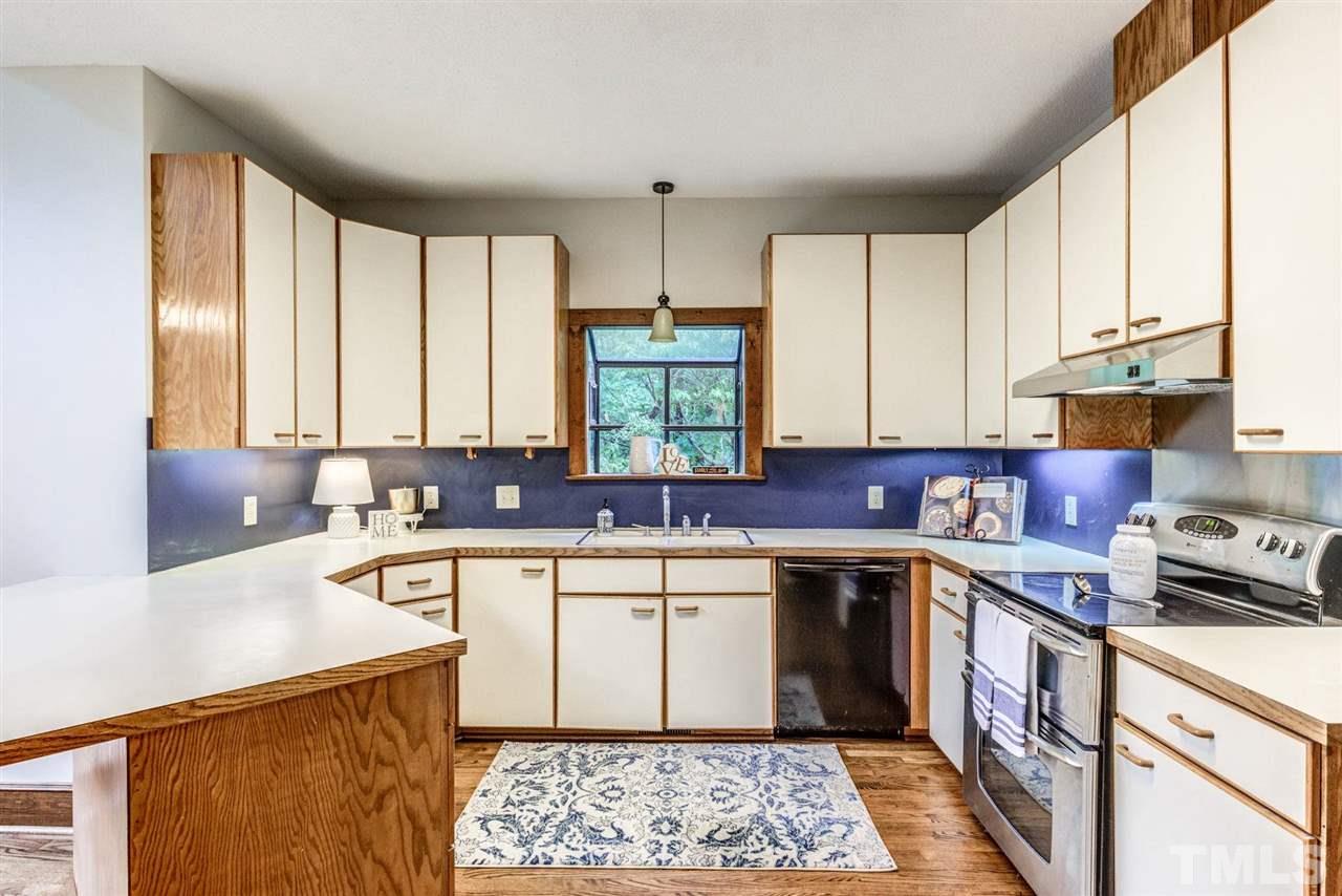 7604 Glenharden Drive Raleigh, NC 27613 - Photo 10 of 30 a kitchen with a sink stove and cabinets