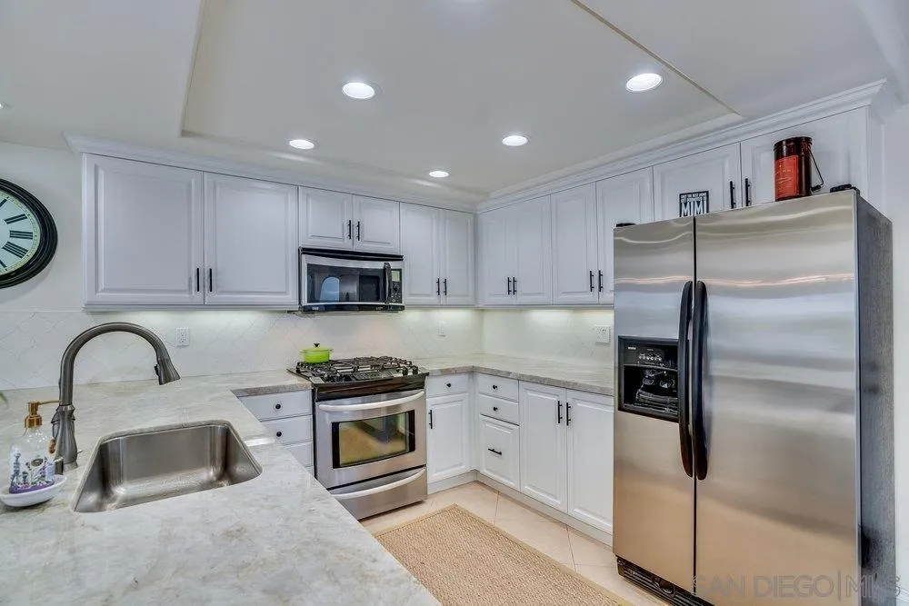 4 GingerTree Lane Coronado, CA 92118 - Photo 13 of 54 a kitchen with stainless steel appliances granite countertop a sink and a refrigerator
