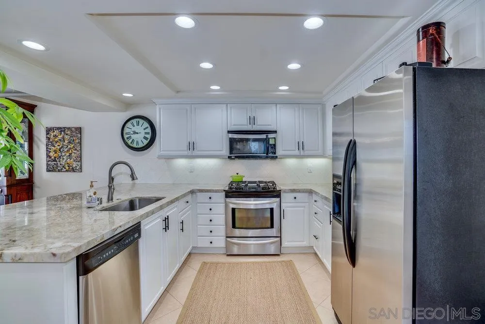 4 GingerTree Lane Coronado, CA 92118 - Photo 14 of 54 a kitchen with stainless steel appliances granite countertop a refrigerator and a sink