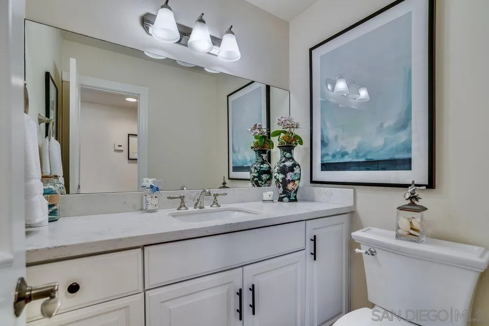 4 GingerTree Lane Coronado, CA 92118 - Photo 16 of 54 a bathroom with a sink a large mirror and a toilet