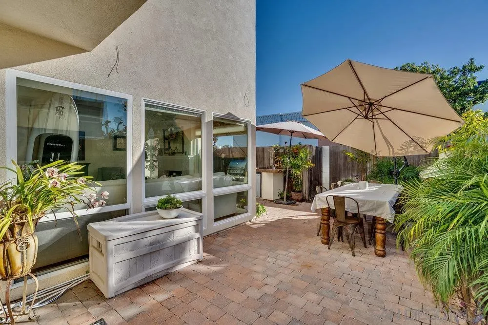 4 GingerTree Lane Coronado, CA 92118 - Photo 21 of 54 a view of a patio with table and chairs under an umbrella